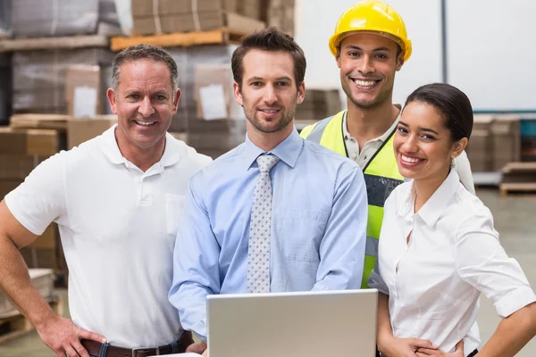 Warehouse managers and worker smiling — Stock Photo, Image