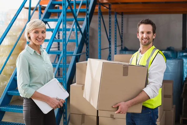 Worker holding box with manager — Stock Photo, Image