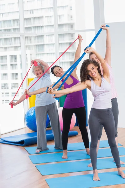 Happy friends exercising with resistance bands — Stock Photo, Image