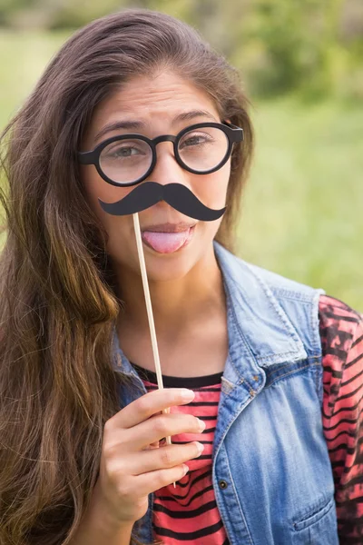 Pretty brunette with fake mustache — Stock Photo, Image