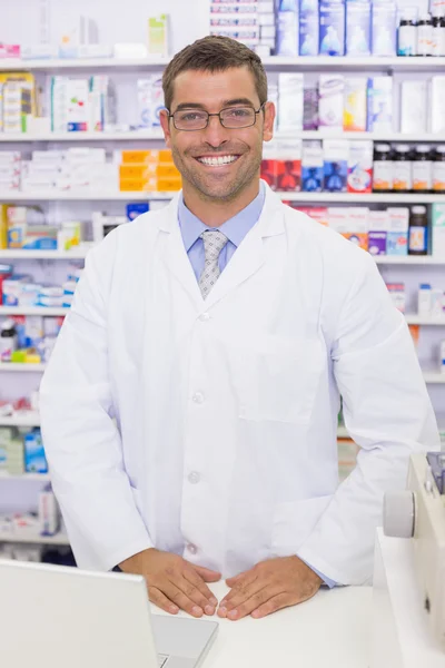 Handsome pharmacist using the computer — Stock Photo, Image