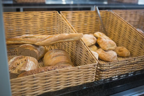Baskets with breads freshly baked and tongs — Stock Photo, Image