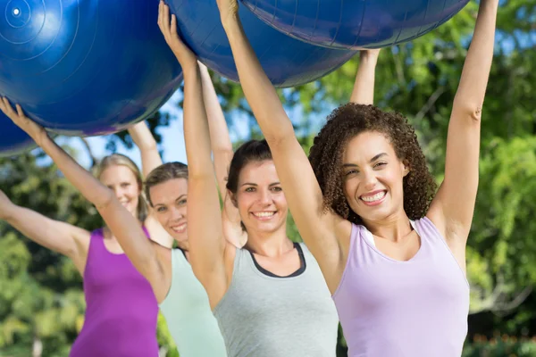 Fitness group holding exercise balls — Stock Photo, Image