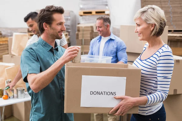 Two volunteers holding donations box — Stock Photo, Image