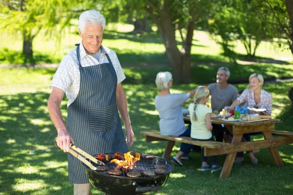 Happy grandfather doing barbecue — Stock Photo, Image
