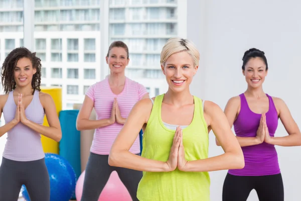Women with hands joined exercising at gym — Stock Photo, Image
