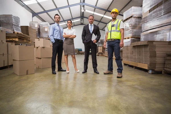 Warehouse team standing looking at camera — Stock Photo, Image