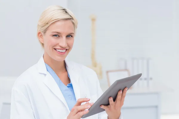 Confident female doctor using digital tablet — Stock Photo, Image