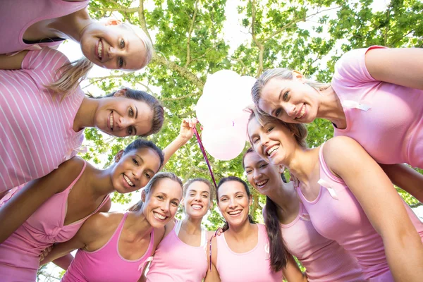 Smiling women in pink for breast cancer awareness — Stock Photo, Image