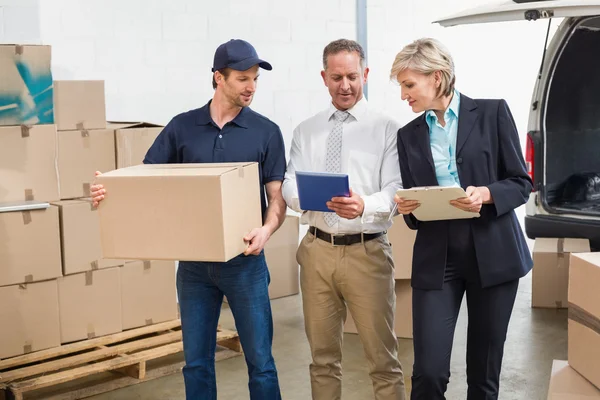 Delivery driver checking his list on tablet — Stock Photo, Image