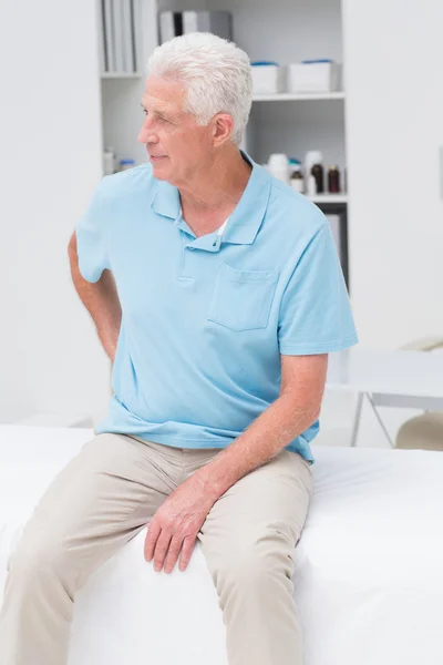 Человек, страдающий от боли в спине в клинике — стоковое фото