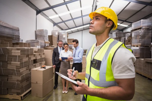 Warehouse manager checking his inventory — Stock Photo, Image
