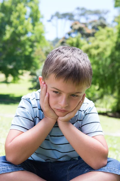 Little boy feeling sad in the park — Stock Photo, Image