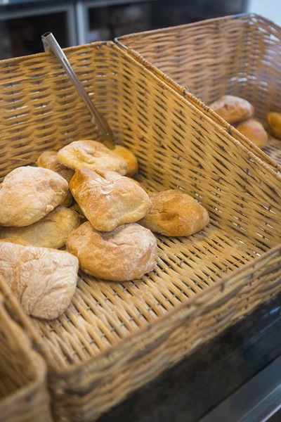 Baskets with delicious breads and tongs — Stock Photo, Image