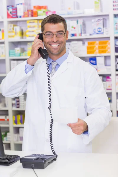 Happy pharmacist on the phone — Stock Photo, Image