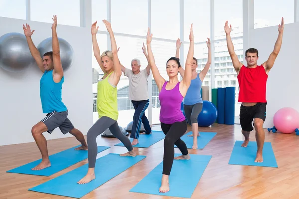 Personas que hacen ejercicio con las manos levantadas en el gimnasio — Foto de Stock