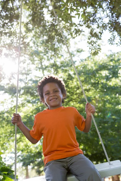 Little boy on swing in the park — Stock Photo, Image