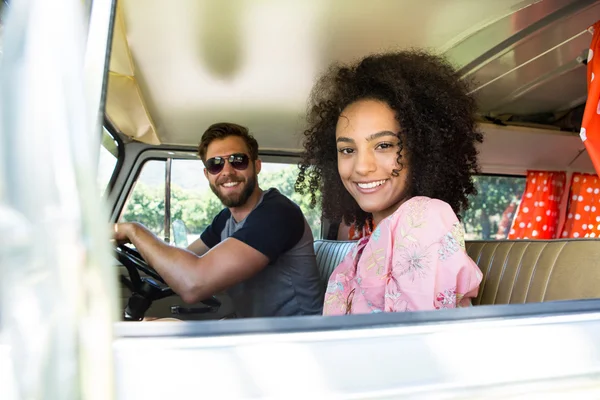 Hipster couple driving in camper van — Stock Photo, Image