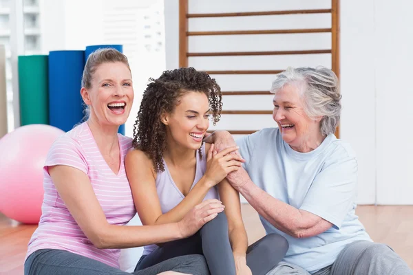 Playful female friends sitting in gym — Stock Photo, Image