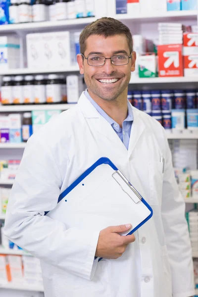 Happy pharmacist holding clipboard — Stock Photo, Image