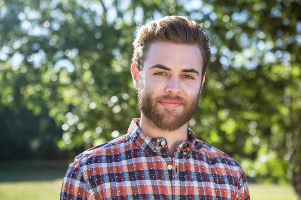 Handsome hipster smiling at camera — Stock Photo, Image