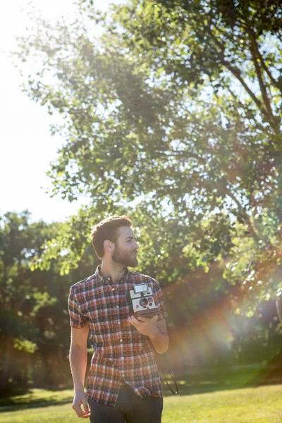 Handsome hipster using vintage camera — Stock Photo, Image