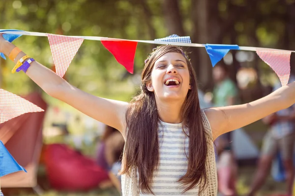 Pretty hipster posing for camera with flags — Stock Photo, Image