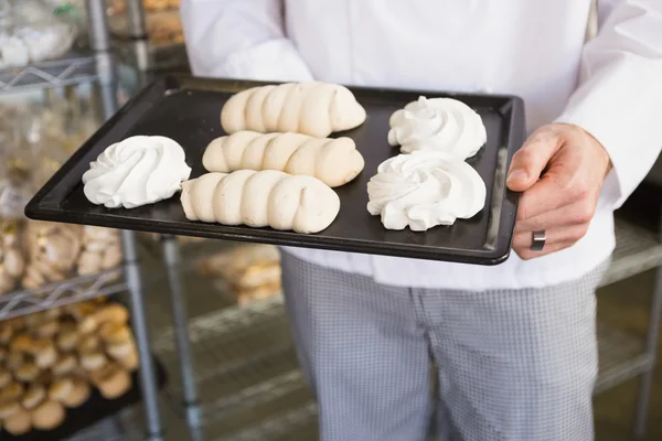 Baker holding meringue tray — Stock Photo, Image