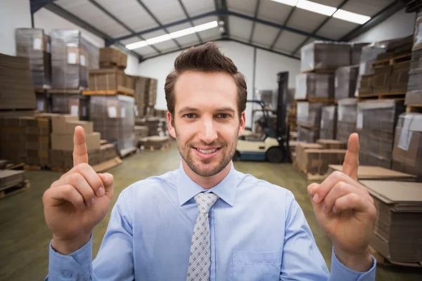 Warehouse manager pointing up with finger — Stock Photo, Image