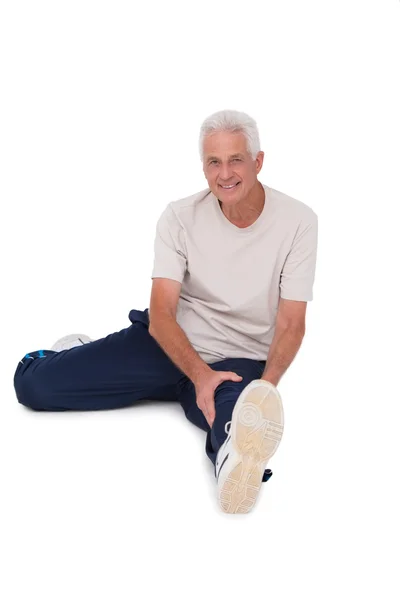 Senior man stretching his leg — Stock Photo, Image