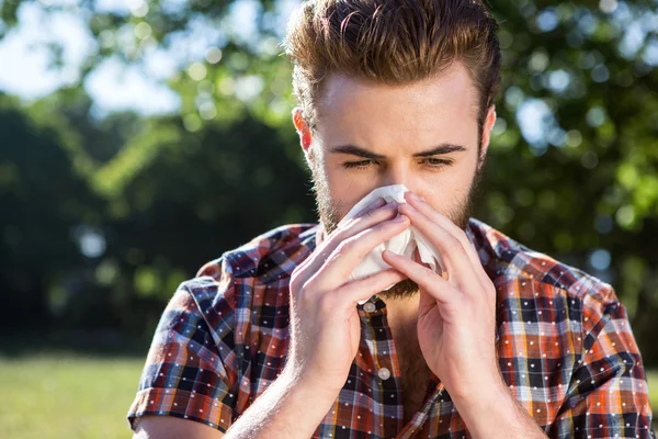 Handsome hipster blowing his nose — Stock Photo, Image