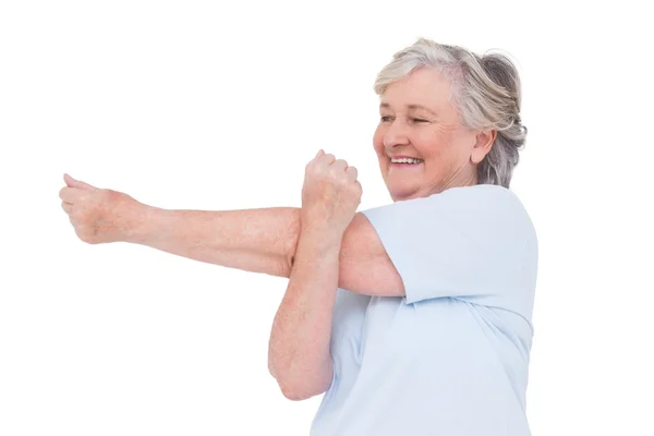 Senior woman stretching her arms — Stock Photo, Image