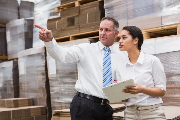 Warehouse manager and boss checking inventory — Stock Photo, Image