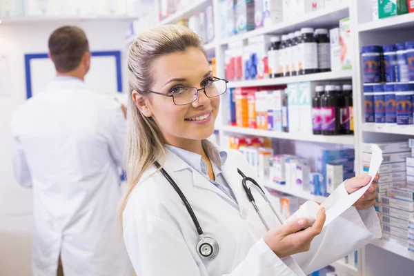 Pharmacist taking medicine from shelf — Stock Photo, Image