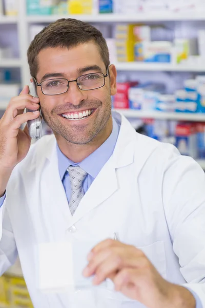 Happy pharmacist on the phone — Stock Photo, Image