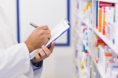 Pharmacist writing on clipboard clipart