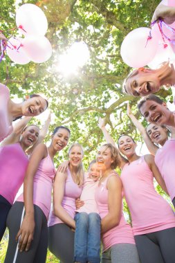 Smiling women in pink for breast cancer awareness clipart