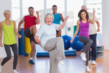 People doing power fitness exercise at fitness studio clipart