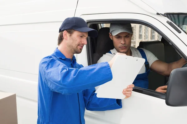 Conductor de entrega mostrando al cliente dónde firmar — Foto de Stock