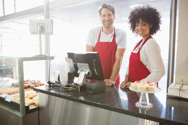 Colleagues posing behind the counter — Stock Photo, Image