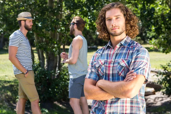 Young man frowning at camera in park — Stock Photo, Image