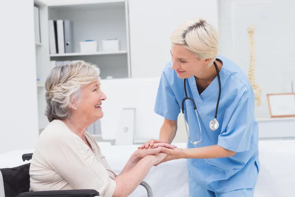 Sjuksköterska hålla äldre patienter händer — Stockfoto