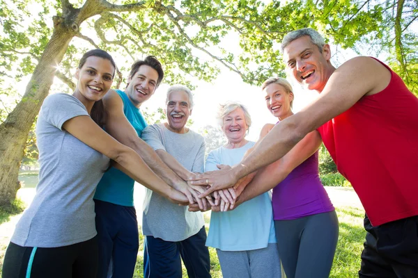 Happy athletic group putting their hands together — Stock Photo, Image