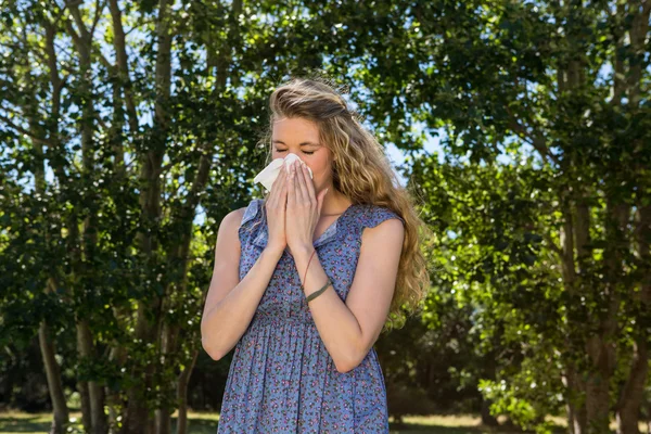 Pretty blonde blowing a her nose — Stock Photo, Image