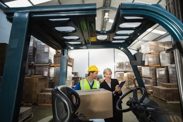Warehouse manager talking with forklift driver — Stock Photo, Image