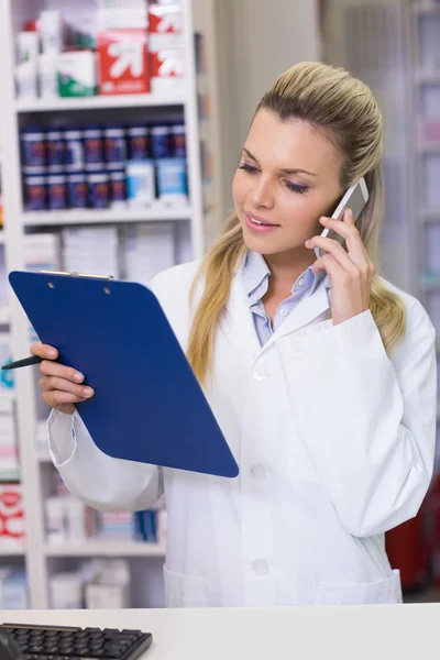 Young pharmacist on the phone — Stock Photo, Image
