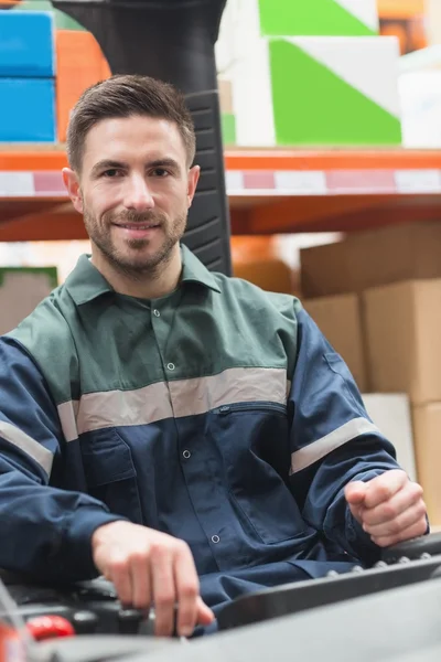 Smiling driver operating forklift machine — Stock Photo, Image