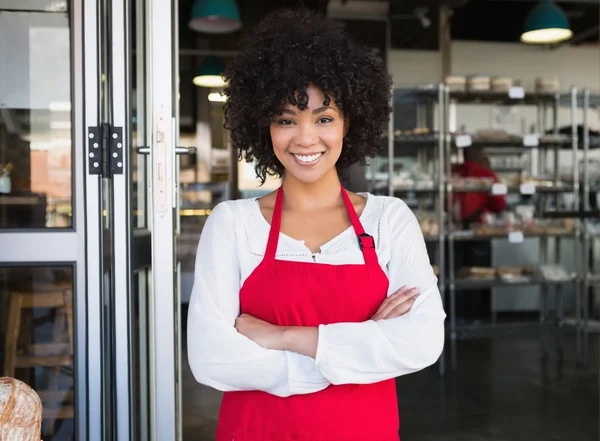 Server in red apron with arms crossed — Stock Photo, Image