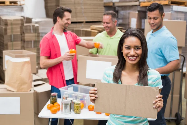 Smiling volunteer showing a poster — Stock Photo, Image