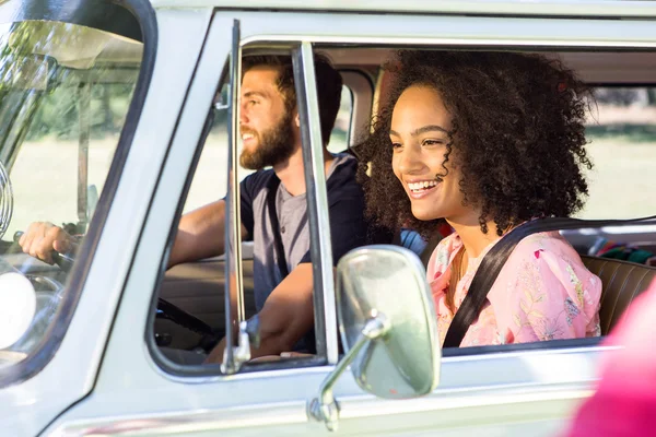 Hipster couple driving in camper van — Stock Photo, Image